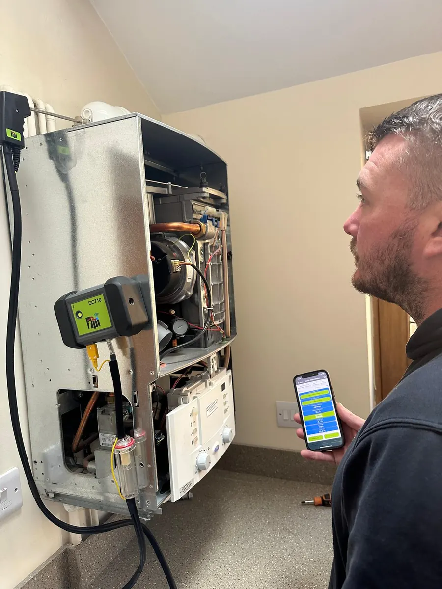 Josh servicing a boiler with a flue gas analyser